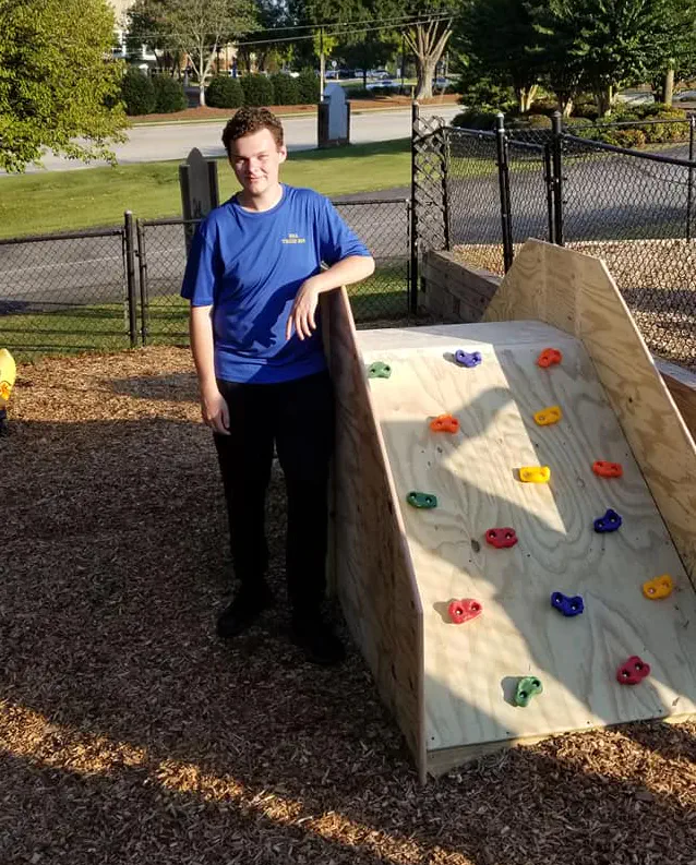 Logan Douglas standing with Eagle project